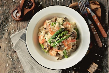Italian risotto with shrimps, mushrooms, asparagus and parmesan. Healthy food.
