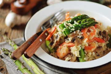 Italian risotto with shrimps, mushrooms, asparagus and parmesan. Healthy food.
