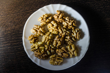 Pieces of walnuts on the white plate
