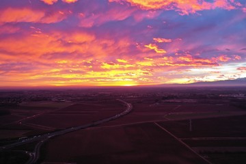 Naklejka na ściany i meble view from above. unbelievably beautiful sunset. clouds are highlighted in pink, purple and yellow-orange colors