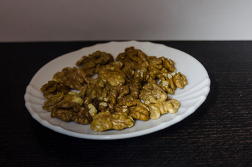 Pieces of walnuts on the white plate