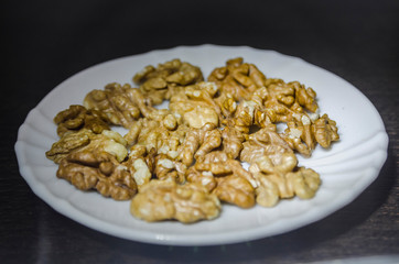 Pieces of walnuts on the white plate