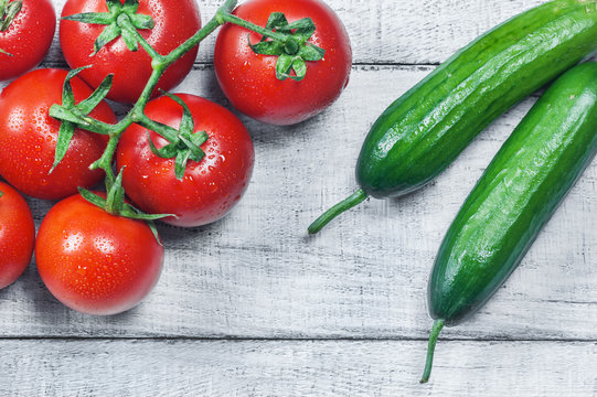 Ripe Fresh Grape Tomatoes And Cucumbers On White Wooden Background. Cherry Tomato And Cucumber Vegetable Salad Concept