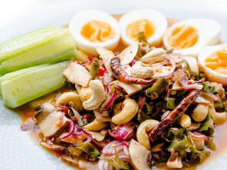 Thai wing bean spicy salad with boiled eggs and fresh cucumber, chili, Cashew nuts. Thai food. or Yum Tua Poo