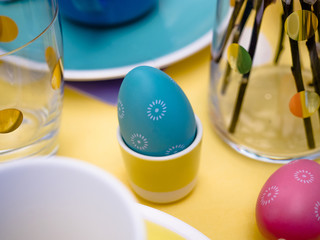 Beautiful colorful festive Easter table setting with Easter Bunny, Easter eggs, Happy Easter in pastel Spring color theme
