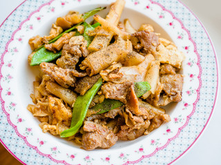 Thai food-Stir fried flat rice Noodles with sweet soy sauce (Pad See Ew) vegetable and minced pork as close-up, a famous food in Thailand.