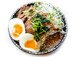 Chinese noodles with roasted meat pork or duck top and egg, Traditional noodles soup with green onion and egg.