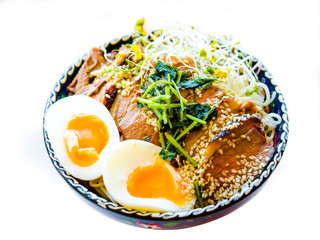 Chinese noodles with roasted meat pork or duck top and egg, Traditional noodles soup with green onion and egg.