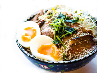 Chinese noodles with roasted meat pork or duck top and egg, Traditional noodles soup with green onion and egg.