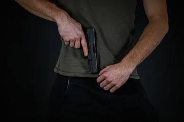 Man try to hide his pistol under his pants