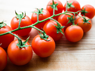 Fresh cherry tomatoes on rustic wooden background, Preparing for cooking dinner. Tomato on wooden table background top view.