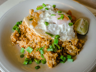 Thai fried rice with spicy Tom Yum sauce and shrimps, (Selective Focus), Thai street food, homemade food.