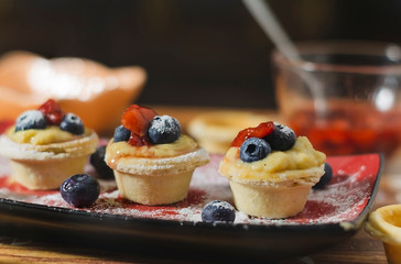 tart stuffed with cream, berries and jam of fresh strawberries