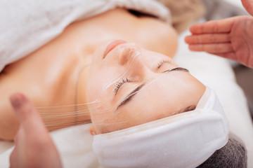 Nice pleasant woman having her skin treated