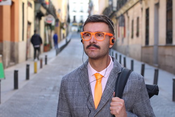 Hipster businessman listening to music