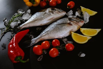 Fish seafood dorado, raw food on black background,  nutrition.