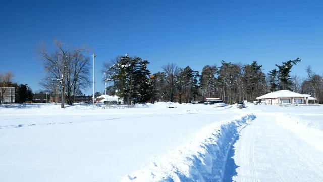 Car Drives Onto Frozen Lake Bemidji to park with other University student's vehicles on the lake in winter.