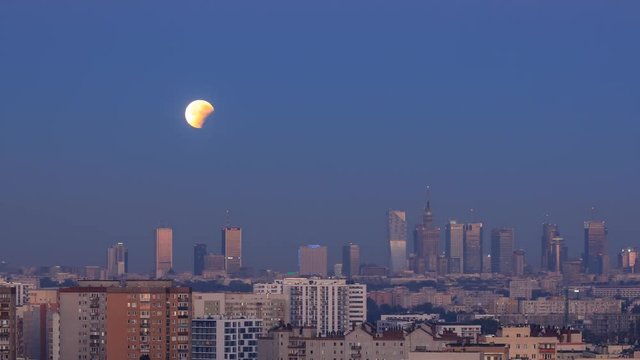 Moon during total lunar eclipse setting behind Zlota 44 in Warsaw, Poland. Video with camera motion.