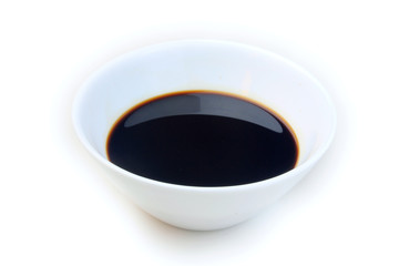 Soy sauce in a ceramic bowl isolated on white background, with clipping path