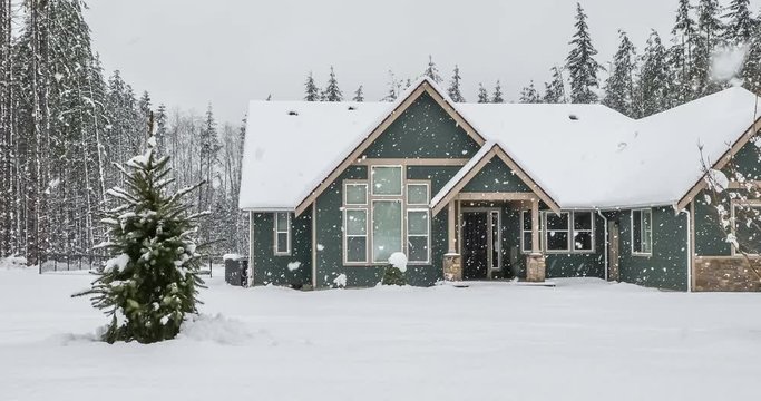 Modern American home exterior on a snowy winter day; 4k 60fps footage