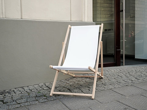 Mock up, Blank Sunbed, deck chair in a front of a shop on a pedestrian path in the old town 