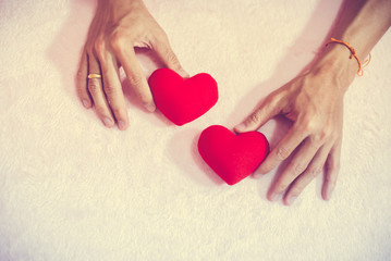 Fototapeta premium Top view hand holding red heart for valentine day concept, romantic love forever.