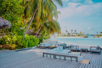 Beautiful tropical Maldives island with white sandy beach and sea in  sunshine  day for holiday ,summer, vacation .