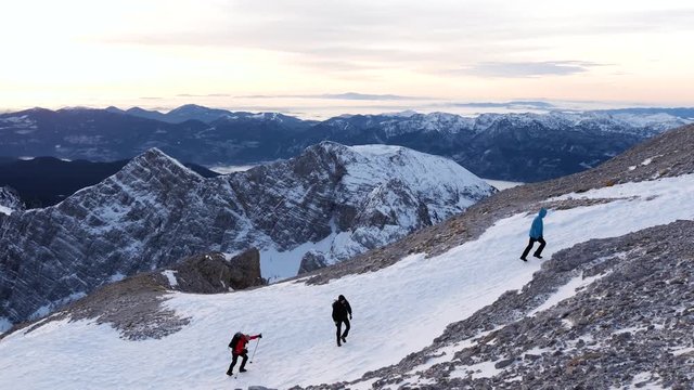 A group of mountaineers hiking up a mountain in the Slovenian Alps.