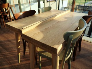 Bright wooden empty table with chairs in a posh, modern, elegant cafe, coffee shop 