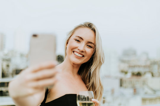 Cheerful Woman Taking A Selfie At A Rooftop Party