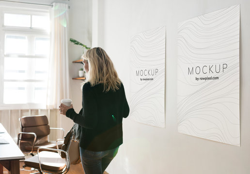 Woman in a working space with poster design mockups