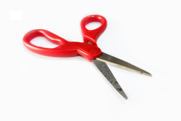Old red scissors on white background isolated, red metallic scissored with open handle, scissors with red plastic handles isolated on white background