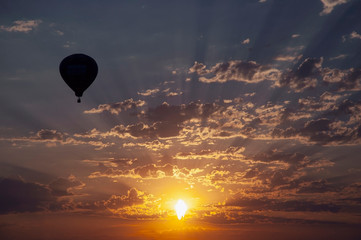 Hot air balloon flying at sunset