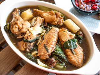 Tom Jab Chai stew in Chinese, Mixed of vegetables soup, tofu, Thai famous cuisine with chicken wings.