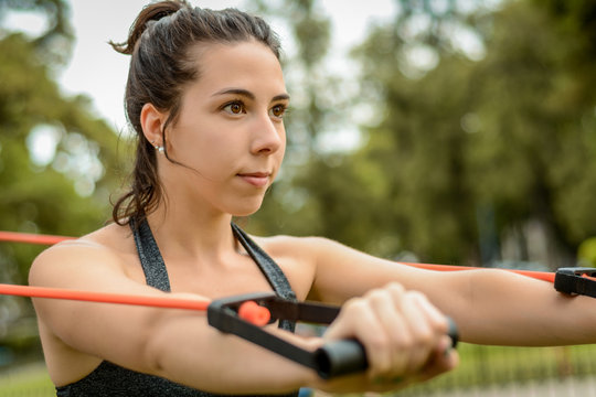 Portrait of young beautiful woman doing exercise at park