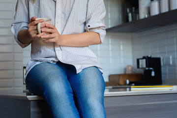 young woman drinking coffee at home