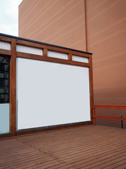 Signboard billboard view of empty white mock up, mock-up signage in a wooden frame with warm colors, wall background, display panel exterior 