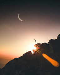 Person Jumping on Mountain Top at Sunset, Fantasy Conceptual Image - 248992797
