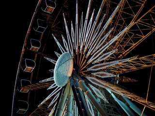 Close up Ferris wheel and night sky joy amusement park, amber sky,  Gdansk, Poland. beautiful wonderland, play park.
