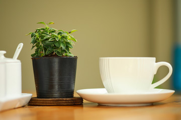 Cup of coffee on the wooden table.