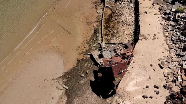 Low aerial shot of shipwreck in low tide from bow to stern. HMQS Gayundah. This gunboat said to be named after an Aboriginal word for lightning.