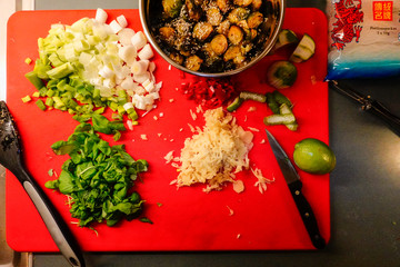 Stockholm, Sweden Home cooking. Ingredients for curry with rice noodles, brussel sprouts, lime, ginger, shallots, basil.