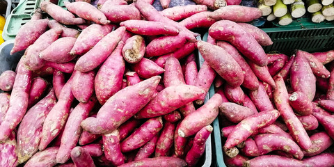 a stack of sweet potato in a mexican market