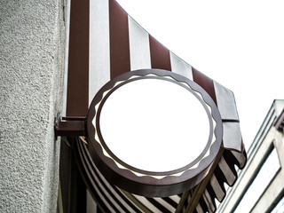 Signboard side view of empty mockup with frame, mock up signage in brown steel metal frame with vintage building city wall background display exterior, bakery shop.