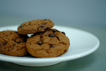 Close up Chocolate cookies in white dish and Light from the window
