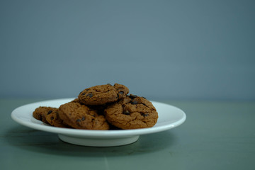 Close up Chocolate cookies in white dish and Light from the window