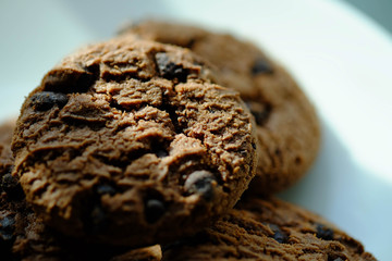 Close up Chocolate cookies in white dish and Light from the window