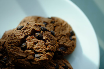 Close up Chocolate cookies in white dish and Light from the window