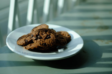 Close up Chocolate cookies in white dish and Light from the window