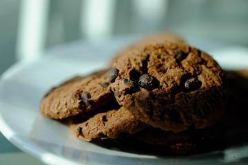 Close up Chocolate cookies in white dish and Light from the window